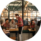 waiter in busy restaurant taking order